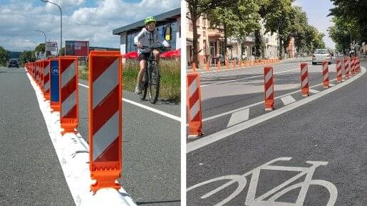 Protected Bike Lane mit weißer Leitschwelle//weißen Leitfüßen Protected Bike Lane mit weißer Leitschwelle/weißen Leitfüßen
